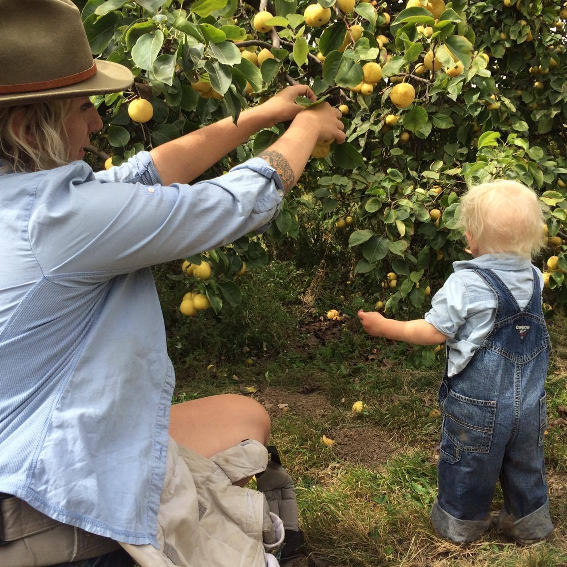 Destiny Hagest and her son picking fruit