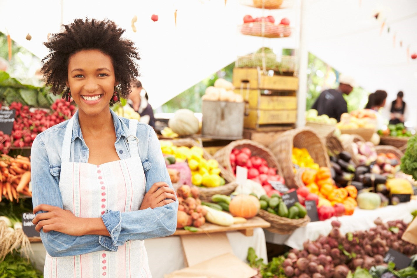 Woman at farmer's market with fresh produce