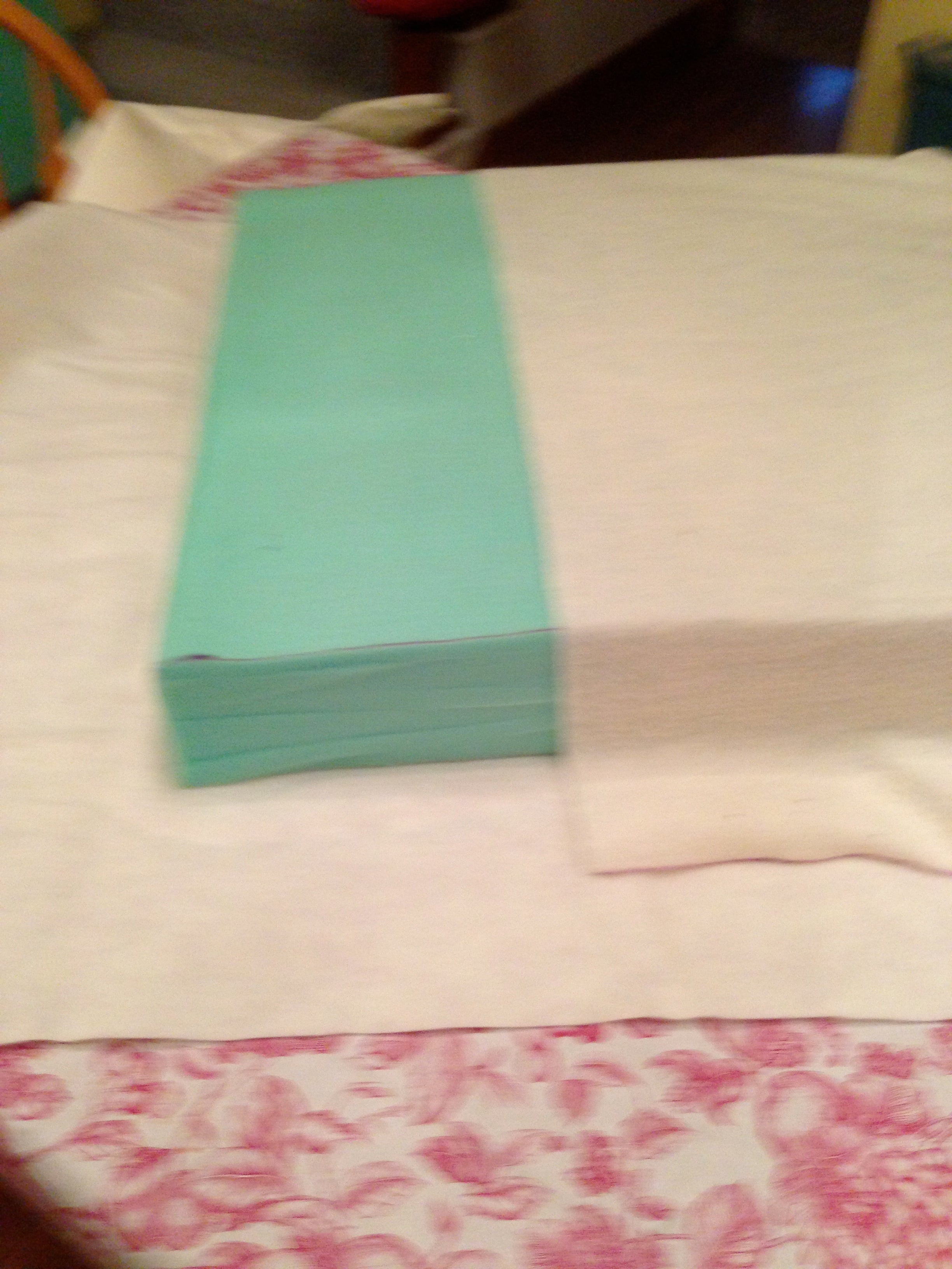 Pull the cotton tightly, and flip the short edge over. Pull that tightly and secure with pins.