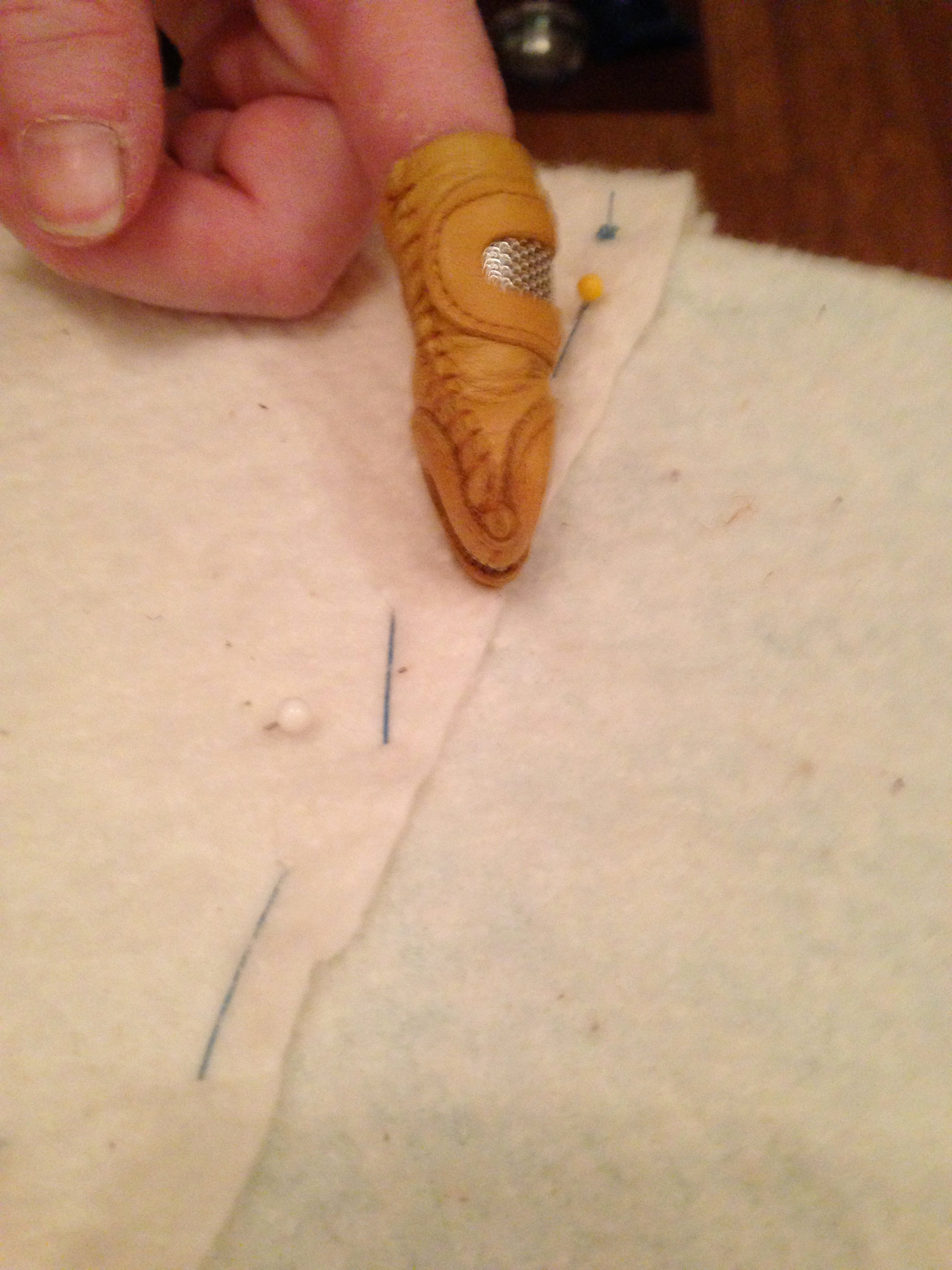 Use a sturdy thread, and don't move the straight pins until you have the segment secured.